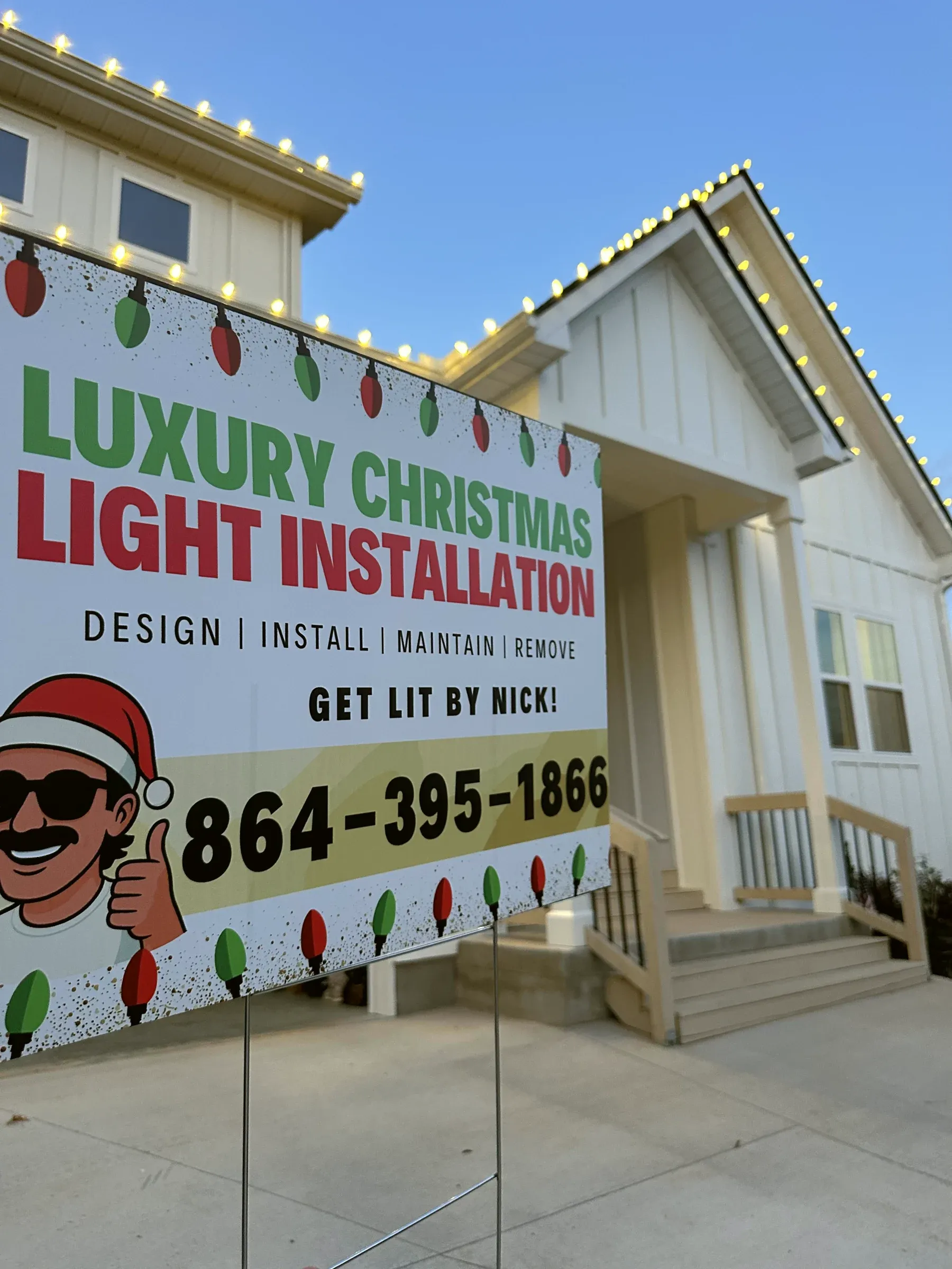 Our yard sign, Luxury Christmas Light Installation, in front of a house with its roofline lit.